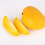 Mango fruit with slice on a white background